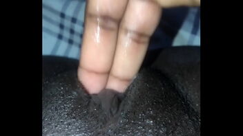 I have a dark-hued vulva and I am fingering it hard and I am cumming.