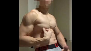 Young Asian man showing off his muscles, masturbating and ejaculating.